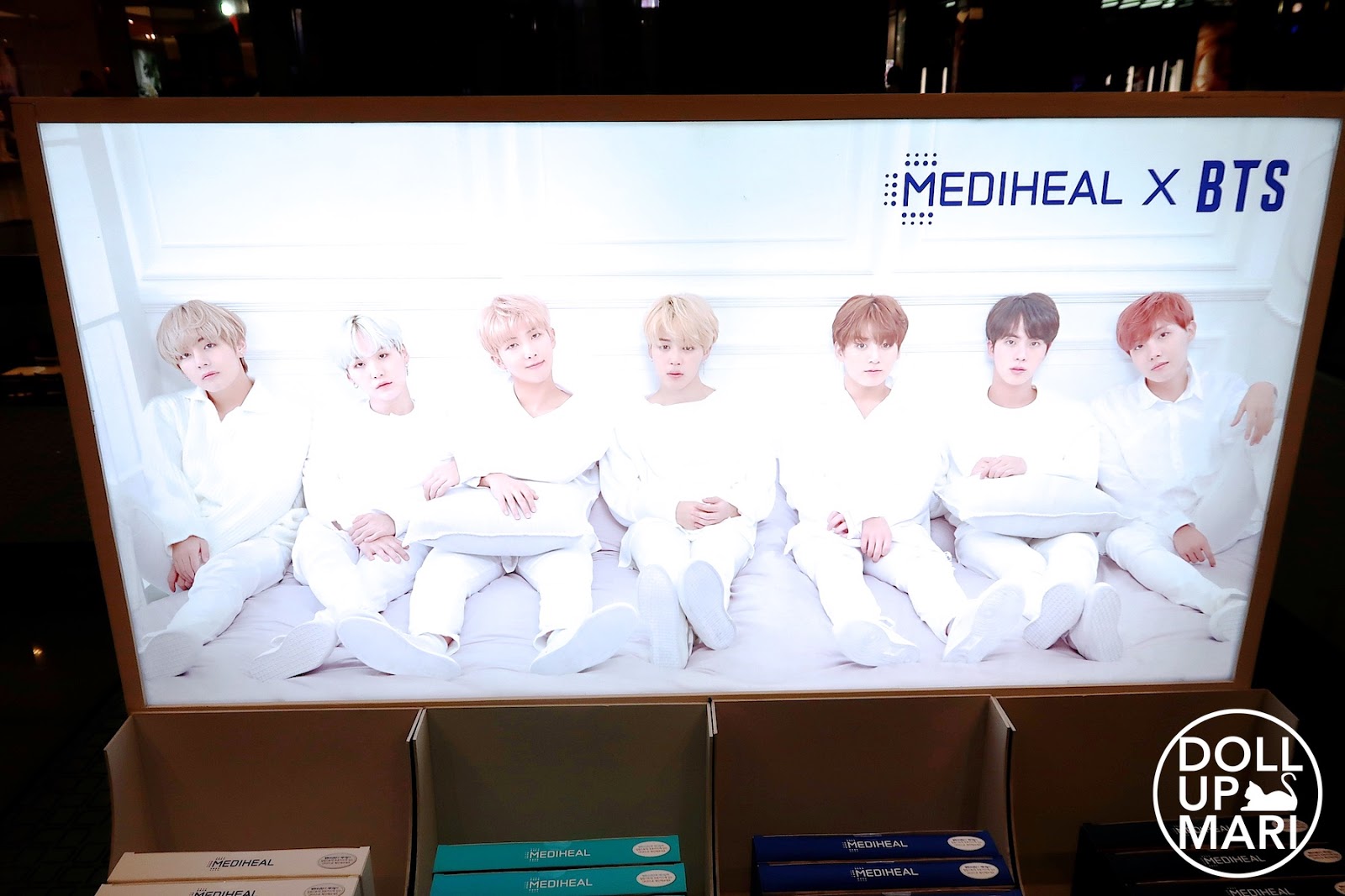 Mediheal X BTS In White Outfits In Light Up Panaflex Signage